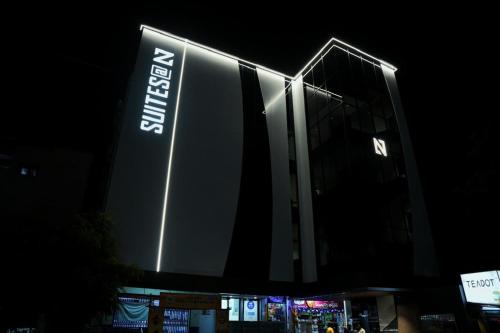 a building with a sign on it at night at SuitesatN in Nellore