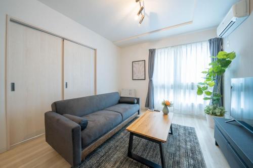 a living room with a couch and a table at Altiplano in Sapporo