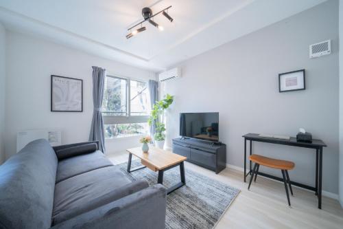 a living room with a couch and a table at Altiplano in Sapporo