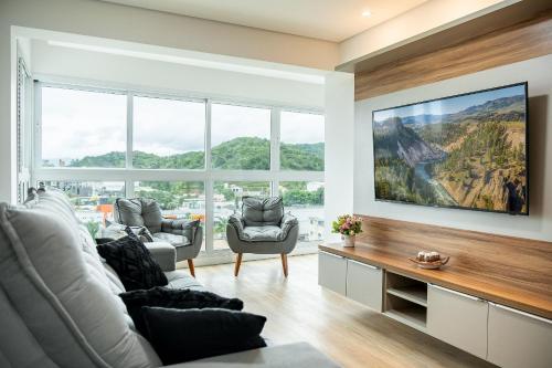 a living room with a view of a mountain at Riviera Concept 2 dorm by Achei Camboriú in Itajaí