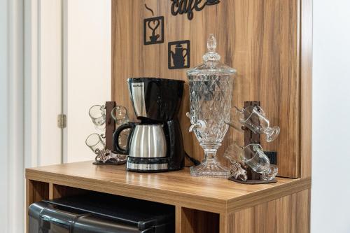 a shelf with a blender and other items on it at Riviera Concept 2 dorm by Achei Camboriú in Itajaí
