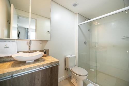 a bathroom with a sink and a toilet and a shower at Riviera Concept 2 dorm by Achei Camboriú in Itajaí