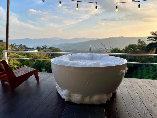 a bath tub sitting on top of a wooden deck at Bella Lunar Villa ดอยแม่สลอง in Mae Salong