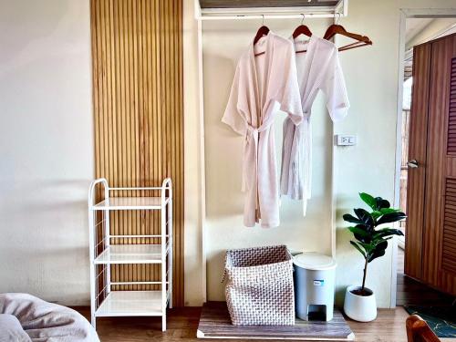 a room with a rack of clothes on a wall at Bella Lunar Villa ดอยแม่สลอง in Mae Salong