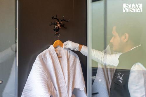 a man in a dressing room with a spider on the wall at The Den by Vieda - Part of StayVista in Karjat