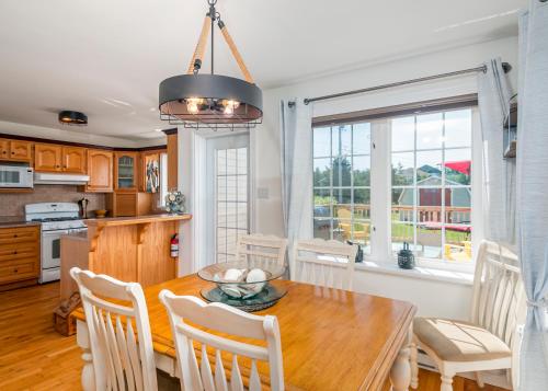 a kitchen and dining room with a table and chairs at The Mooring Ocean Vw 3b Coastal Experience in Topsail