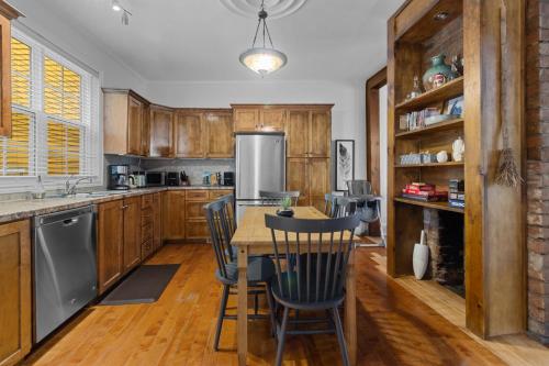 a kitchen with wooden cabinets and a table and chairs at Victoria Family Home King Patio 2 Ba Bbq in St. John's