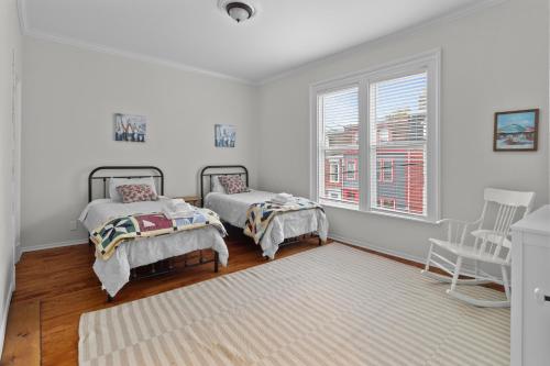 a white room with two beds and a window at Victoria Family Home King Patio 2 Ba Bbq in St. John's