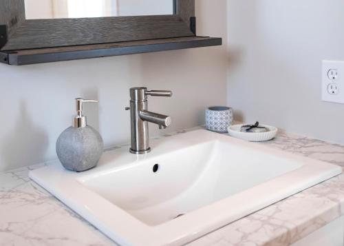 a bathroom sink with a faucet on a counter at The Mooring Ocean Vw 3b Coastal Experience in Topsail