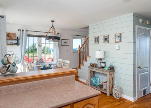 a kitchen with a counter and a dining room at The Mooring Ocean Vw 3b Coastal Experience in Topsail