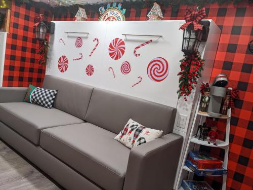 a couch in a room with a wall with candy canes at Olympic Railway Inn in Sequim