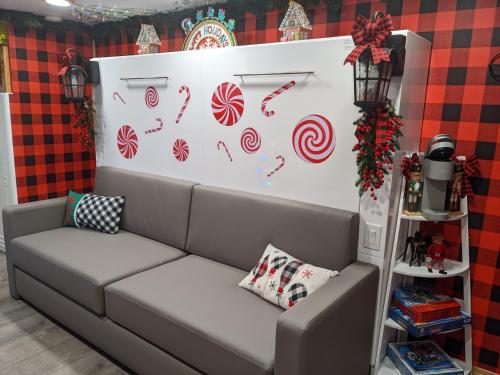 a living room with a couch and a wall with candy canes at Olympic Railway Inn in Sequim