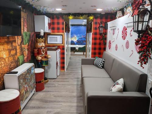a living room with a couch and a refrigerator at Olympic Railway Inn in Sequim
