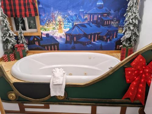 a bath tub with a christmas themed wall at Olympic Railway Inn in Sequim