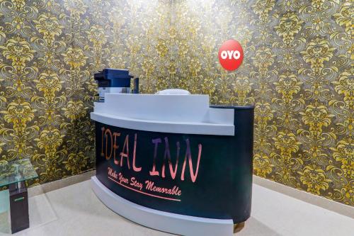 a trash can with a sign on a wall at Hotel O Ideal Inn in Lucknow