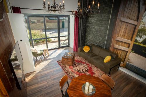 a living room with a couch and a table at Bed & Breakfast Bakker Meijer in Heemskerk
