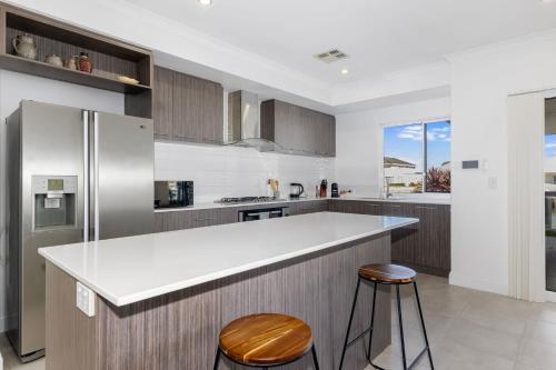 a kitchen with a white counter and a refrigerator at Windward Marina Retreat in Geographe