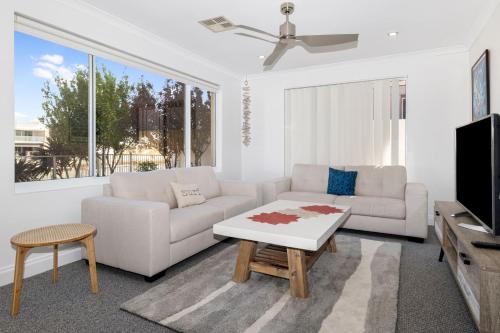 a living room with a couch and a coffee table at Windward Marina Retreat in Geographe
