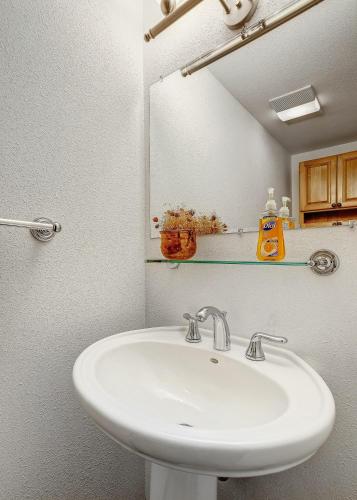 a bathroom with a white sink and a mirror at Peaceful creek view from the deck! Walk to Shuttle in Vail