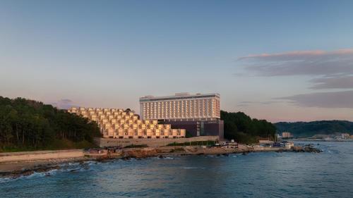 a large building next to a body of water at PANAQ operated by SONO in Yeongdeok