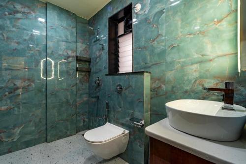 a bathroom with a sink and a toilet at Goa Riviera in Goa