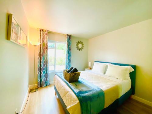 a bedroom with a bed and a window with a basket on it at Cheerful 4 bed, 2 bath with pool near Disneyland in Placentia