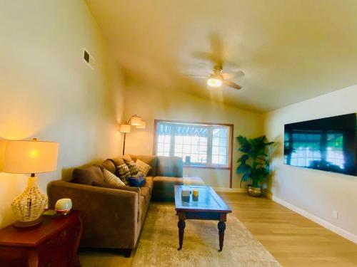 a living room with a couch and a coffee table at Cheerful 4 bed, 2 bath with pool near Disneyland in Placentia