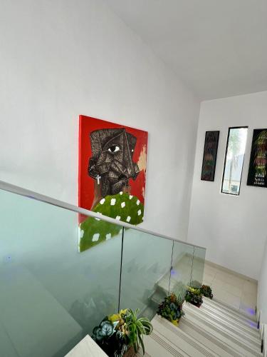 a painting on a wall next to some stairs at Masque Lagos in Lagos