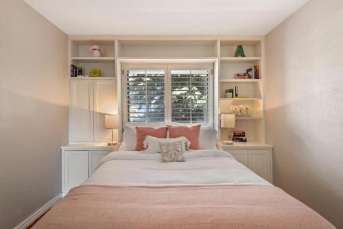 a bedroom with a large bed with a window at Relaxing Escape + Large Deck - 12 Min to Red Rocks in Lakewood