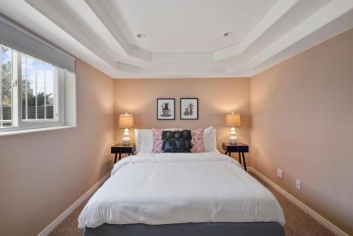 a bedroom with a large bed and two lamps at Relaxing Escape + Large Deck - 12 Min to Red Rocks in Lakewood