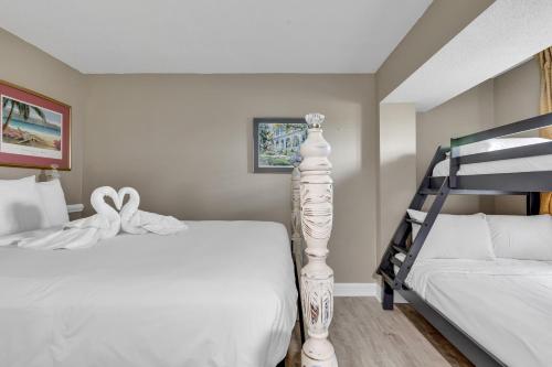 a bedroom with two beds and a bunk bed at Stunning Views Atlantica Towers Condo in Myrtle Beach