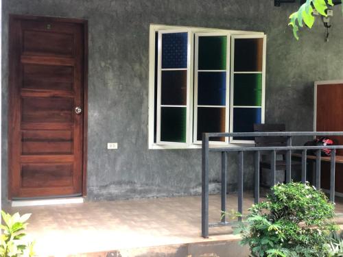 a door and a table in front of a house at Lantacocogarden in Ko Lanta Yai