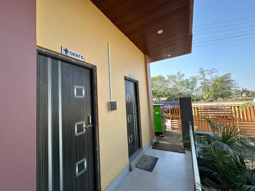 an entrance to a building with two doors at Alpine Resort in Sivasagar