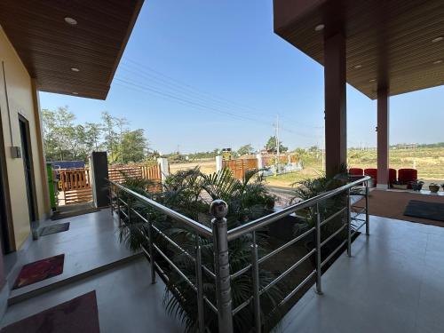 a balcony with plants and a view of a train at Alpine Resort in Sivasagar