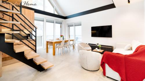 a living room with a staircase and a table at Wonder Home - Domki Hillside tuż przy stoku narciarskim - na terenie kompleksu plac zabaw i zewnętrzna siłownia, sklep, parking in Karpacz