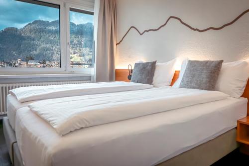 Postel nebo postele na pokoji v ubytování Hotel Merkur - West Station
