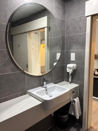 a bathroom with a sink and a mirror at QQ Empire Damansara hotel room in Petaling Jaya