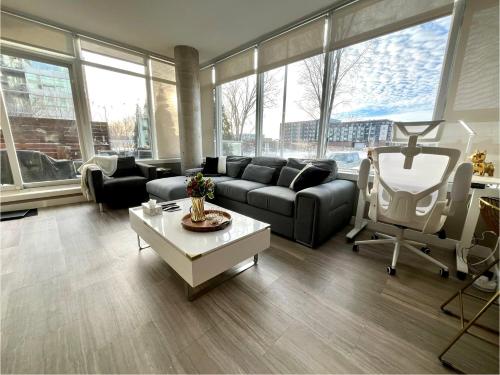 a living room with a couch and a table at Century Park Condo Oasis in Edmonton