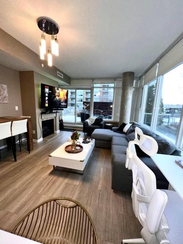 a living room with a couch and a piano at Century Park Condo Oasis in Edmonton
