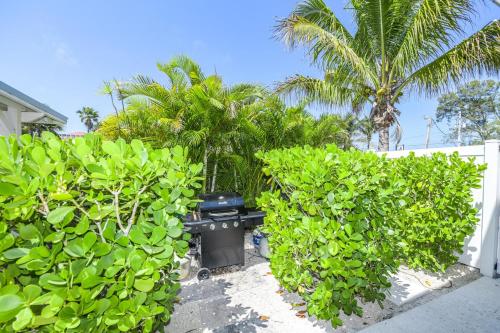 a grill in the middle of some green bushes at Blissful Bay at Bayside Bungalow in Anna Maria