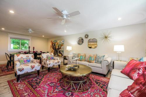 a living room with a couch and a table at Blissful Bay at Bayside Bungalow in Anna Maria