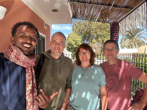 a group of three men and a woman posing for a picture at Karma Kono in Abu Simbel