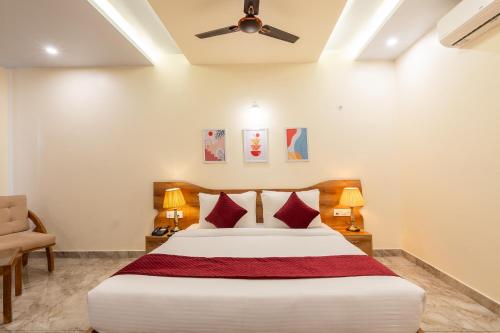 a bedroom with a bed and a ceiling fan at Corbett Tusker Meadows by White Flower in Rāmnagar