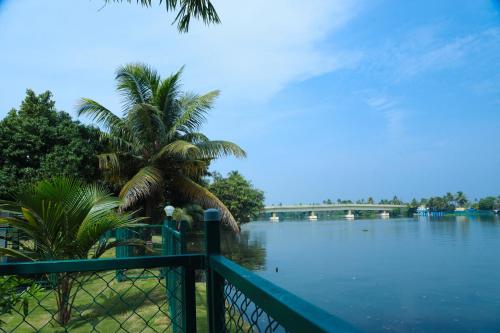 a view of a body of water with a fence at Arayaal Serviced Villa in Champakulam