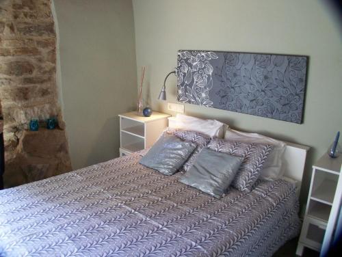 a bedroom with a bed with two pillows on it at Cases Ruralmorella in Morella