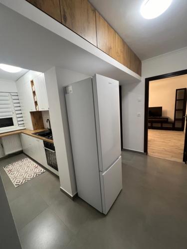 a kitchen with a white refrigerator in a room at A&D Apartament 2 camere in Baia Mare