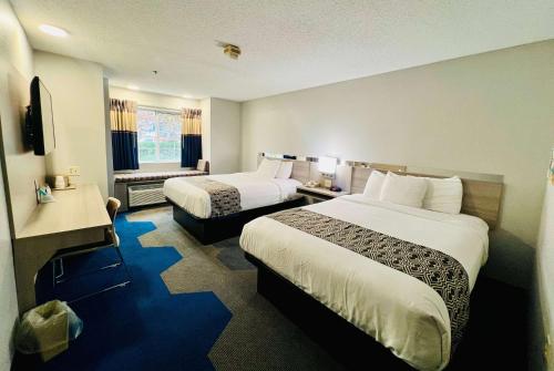 a hotel room with two beds and a window at Microtel Inn Georgetown - Lexington North in Georgetown