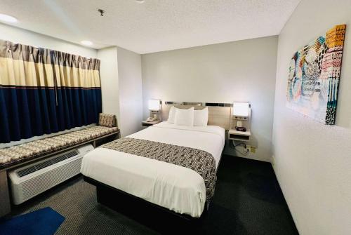 a hotel room with a bed and a window at Microtel Inn Georgetown - Lexington North in Georgetown