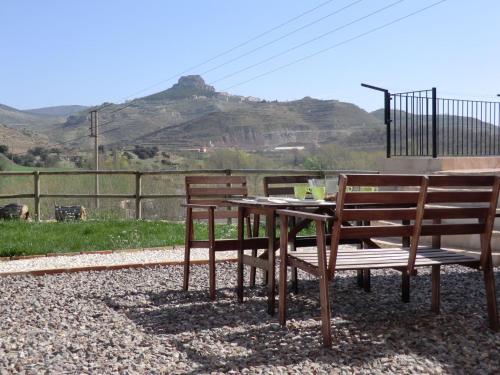 a table with two chairs and a table with at Cases Ruralmorella in Morella