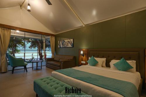 a bedroom with a large bed with a green wall at White Feather Resort Kauncha in Silvassa